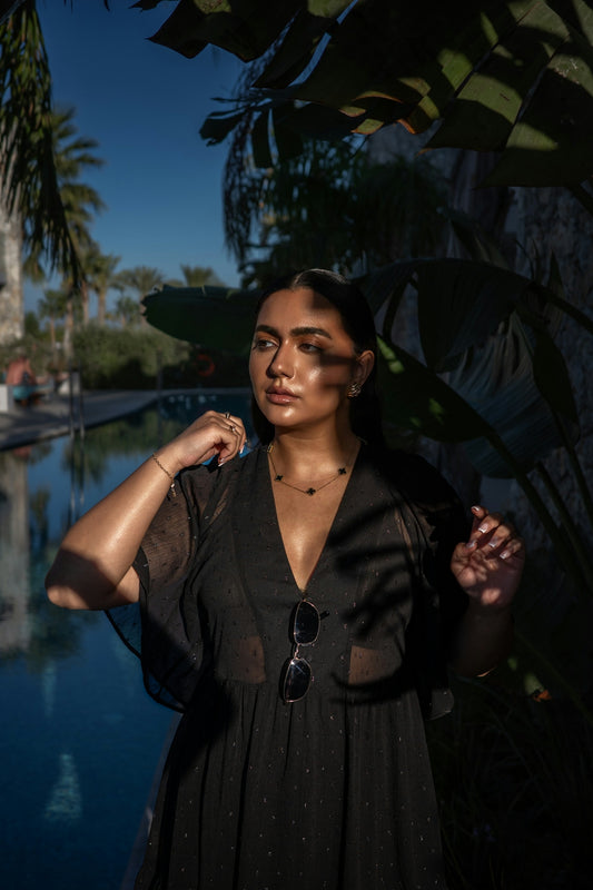 A woman standing next to a body of water